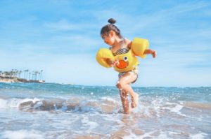 little girl running in the ocean