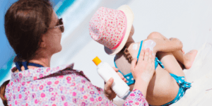 mom putting sunscreen on daughter