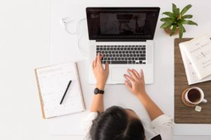 top view photo of a woman working on her laptop