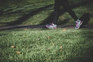 picture of a woman's feet and legs walking on a trail