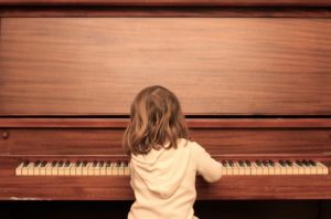 little girl playing piano