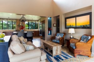 picture of an eclectic home living room with kitchen in the background