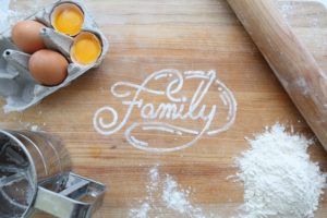 top view of messy countertop with the word "family" spelled in white like flour