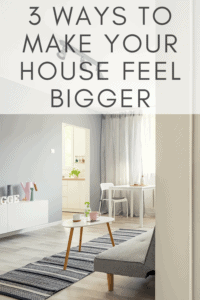 graphic for how to make your house feel bigger picture of a living room with grey and white tones