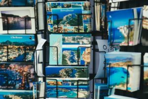 picture of a rack of postcards with beach scenes