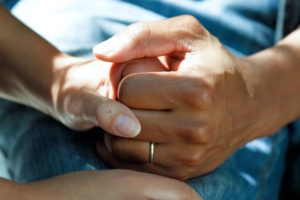 up close picture of two people holding hands