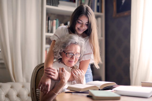 granddaughter hugging grandmother