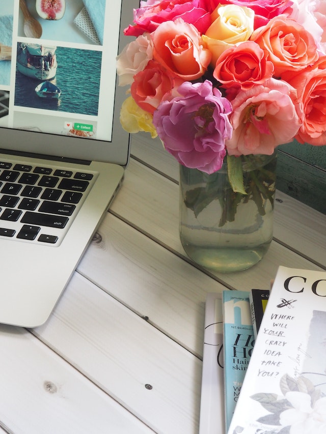 vase of roses on desk