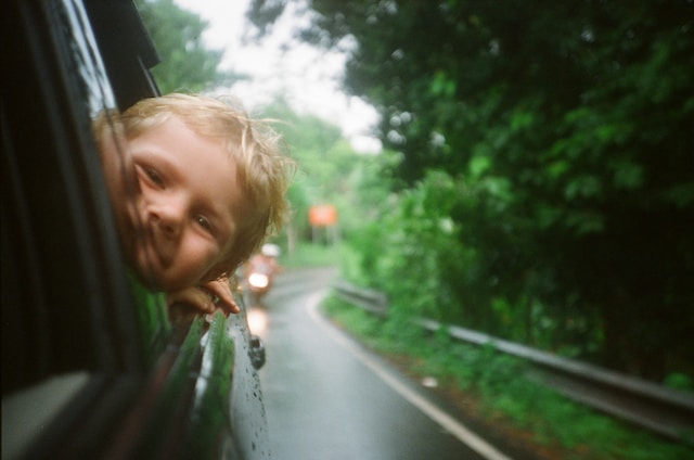 child looking out of car window