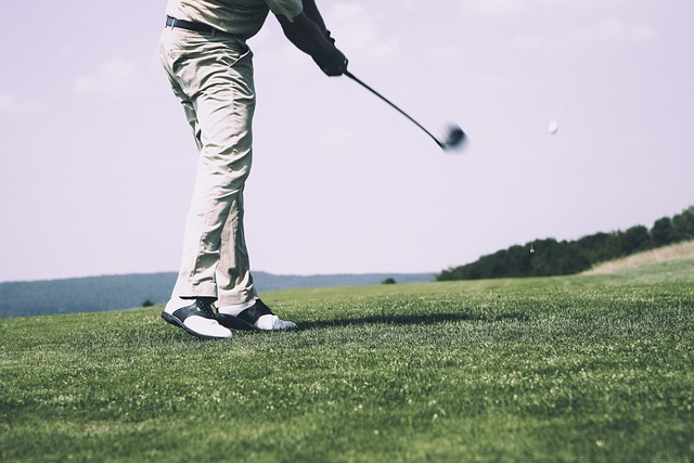 man swinging golf club