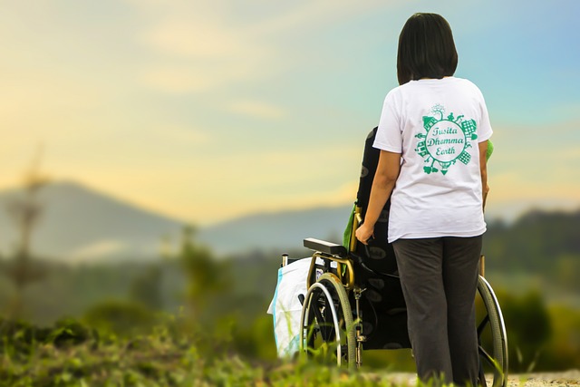 caretaker pushing wheelchair outside