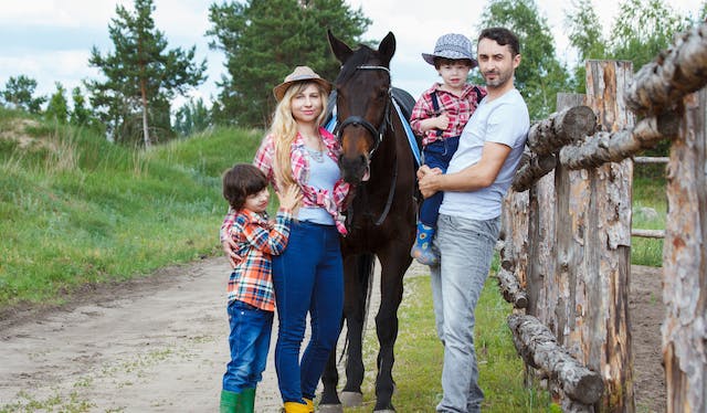 family standing around a horse