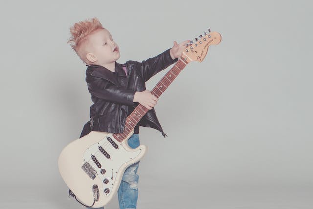 boy playing electric guitar