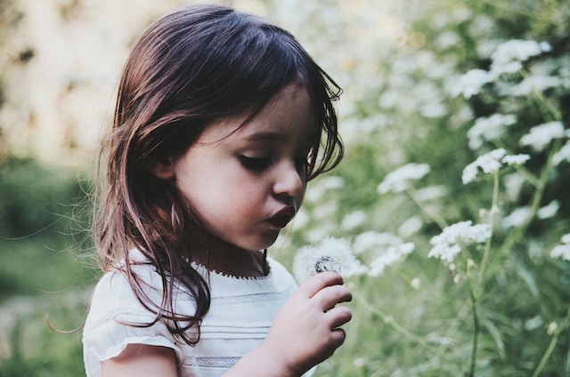 girl smelling flowers