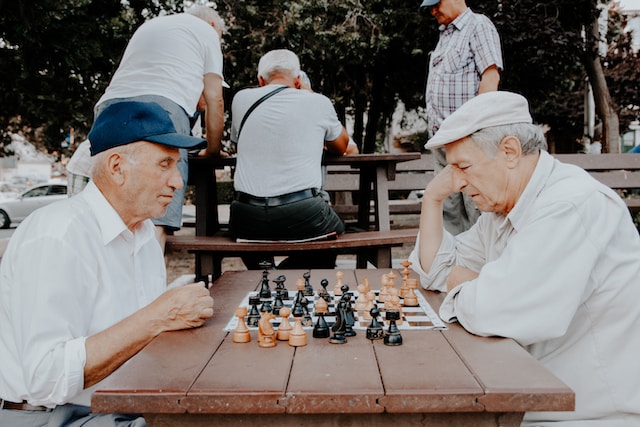 two senior men playing chess