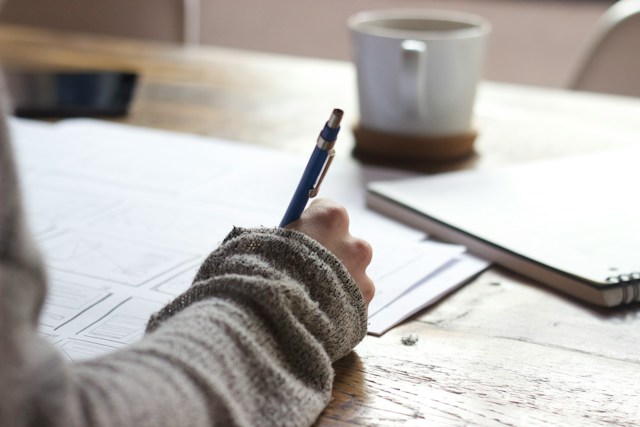 person writing on paper