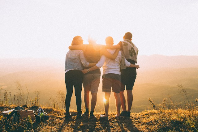 group of people looking at sunset