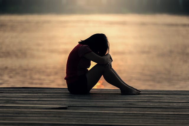 woman sad by water