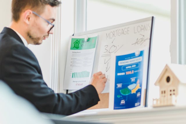 man looking at message board