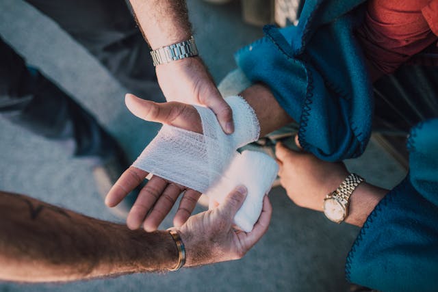 hand getting bandaged