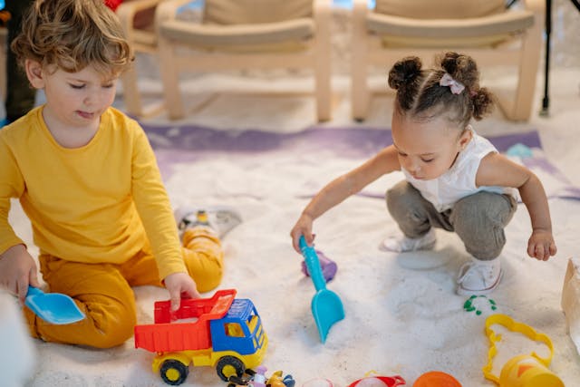 a boy and a girl playing with toys