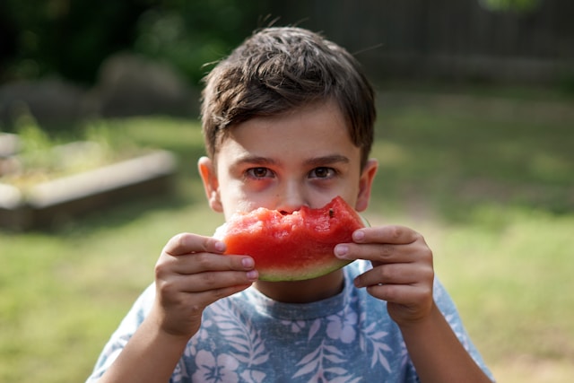 boy eating watermelon
