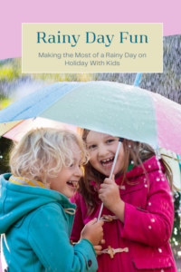 girls laughing under umbrella
