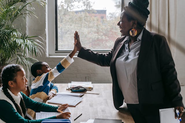 teacher high-fiving student