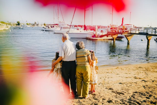 grandparents on beach with grandkids