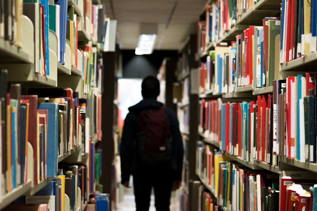 teen walking through library