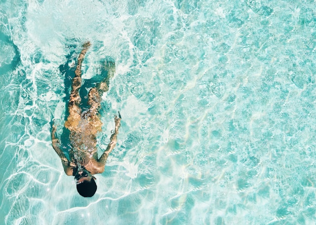 man swimming in pool