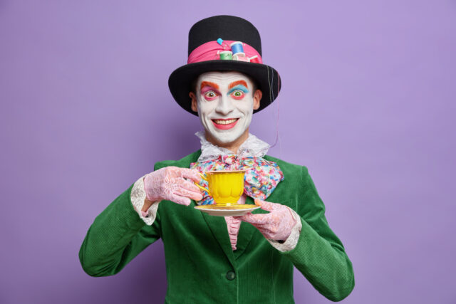 smiling man wearing mad hatter costume