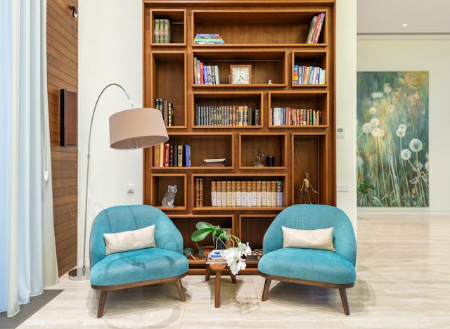 blue chairs in front of bookcase
