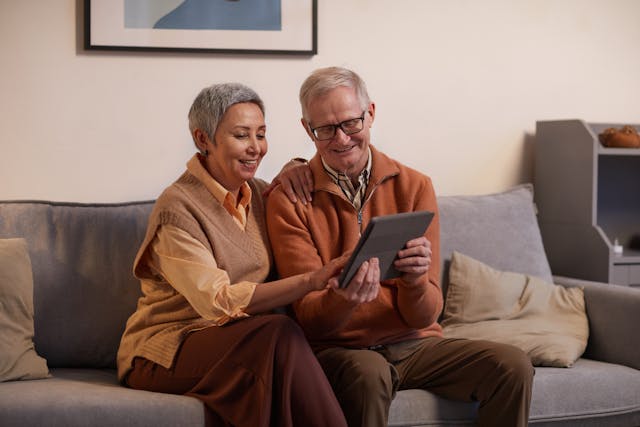 senior couple looking at tablet