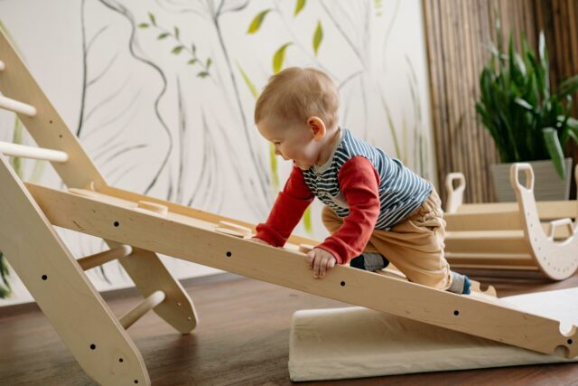 boy climbing on indoor playground