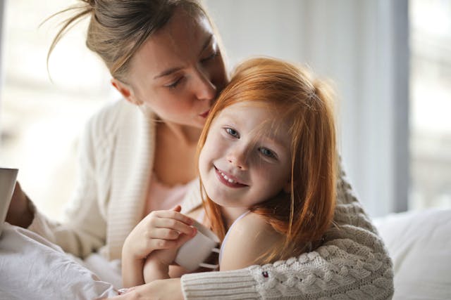 mom snuggling daughter