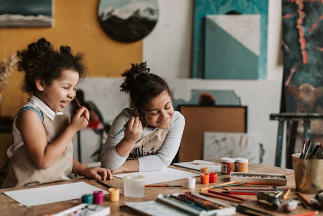 two girls doing an art craft together