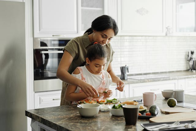mother and daughter cooking in the kitchen
