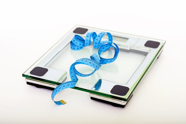scale with blue measuring tape on it