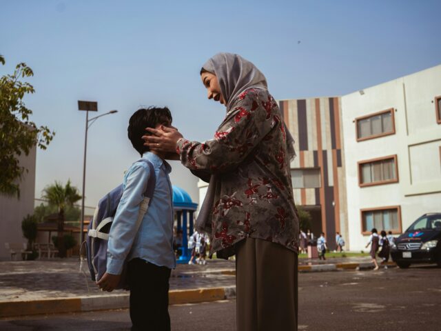 mother saying goodbye to school son