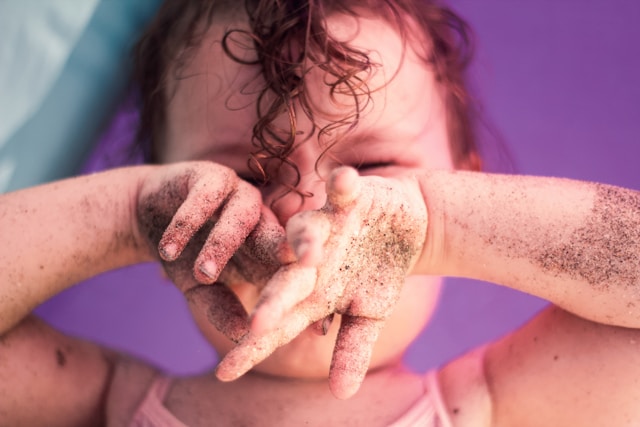 child with dirty hands