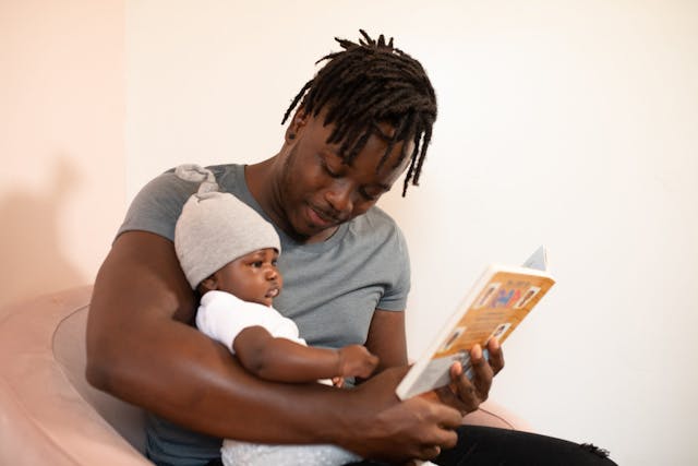 dad reading baby a book