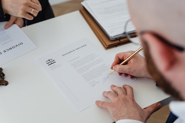 man signing divorce papers