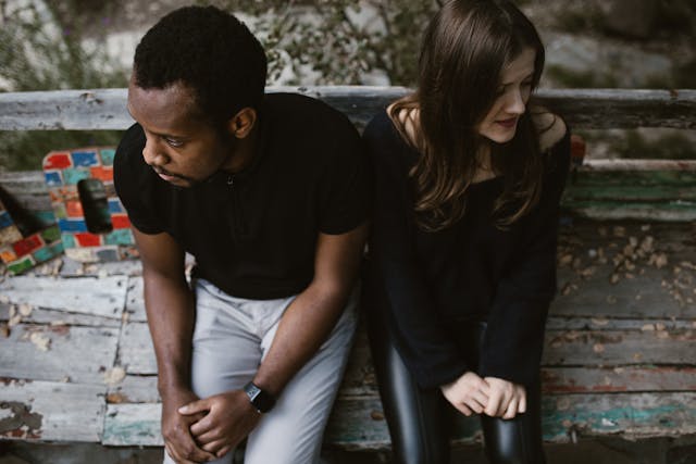 upset couple on park bench