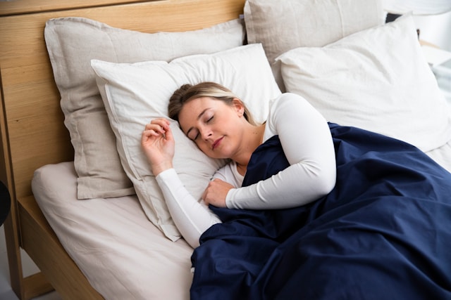 woman sleeping on white sheets
