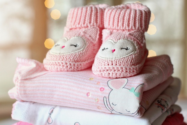 pink baby booties on pink baby blankets