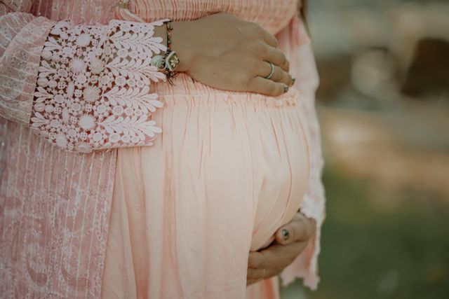 pregnant woman's belly in pink