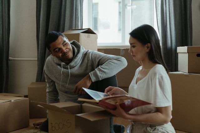 adults packing moving boxes