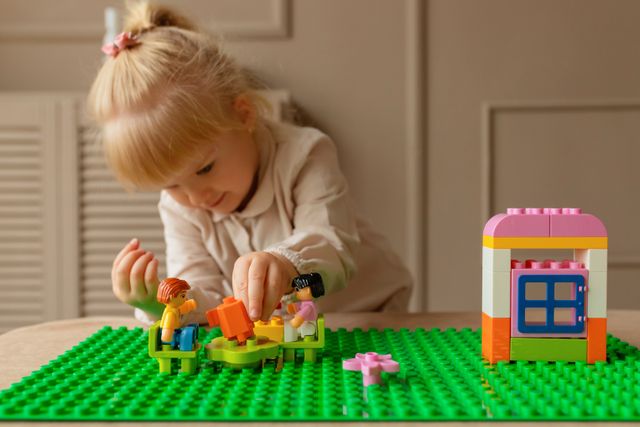 girl playing with legos
