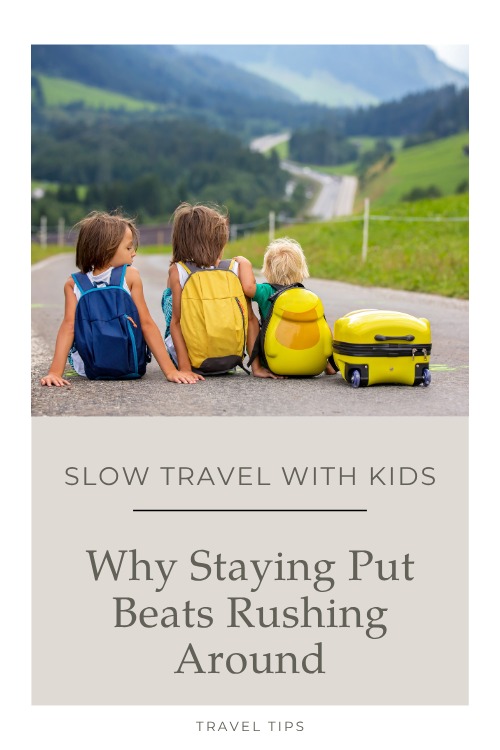 kids sitting in road with suitcase